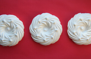 delicious italian dessert white meringues on a pink background