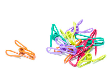 Plastic clothespins of various colors on white background