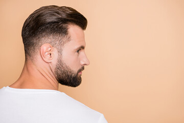Profile side photo of young bristle handsome man serious look empty space isolated over beige color...