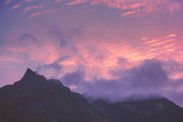 Silhouette of mountains against the purple sunset sky. Norway nature