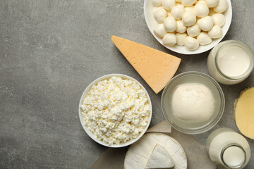 Different fresh dairy products on gray background, top view