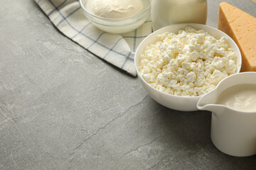 Different fresh dairy products on gray background, space for text