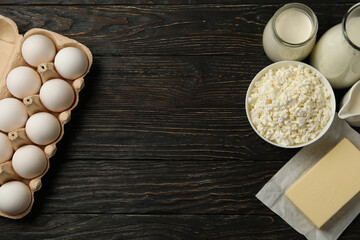 Different fresh dairy products on wooden background, space for text