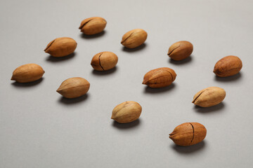 Flat lay with tasty pecan nuts on gray background