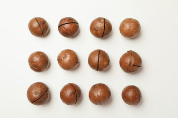 Flat lay with tasty macadamia nuts on white background