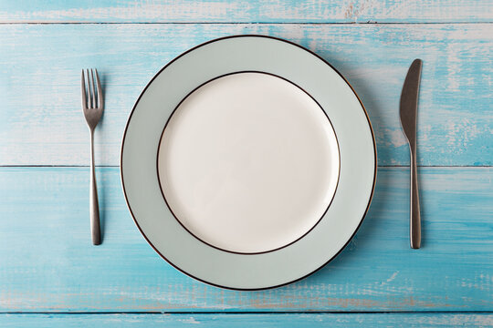 Simple elegance table set with tableware at blue wood background - Powered by Adobe