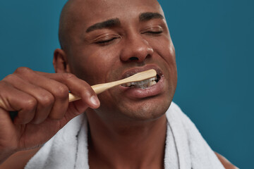 Multiethnic man is enjoying the teeth brushing