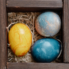 Easter eggs in a box with straw
