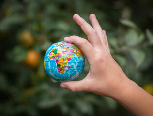 Small globe in a child's hand.