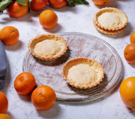 Traditional french lemon tart with tangerines, top view