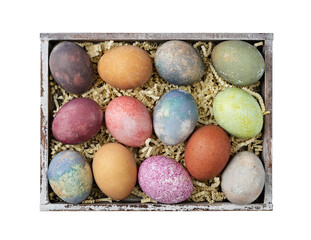 Different easter eggs in a box with straw isolated on white