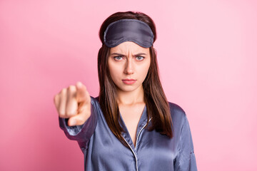 Photo portrait of angry girl pointing finger at camera isolated on pastel pink colored background