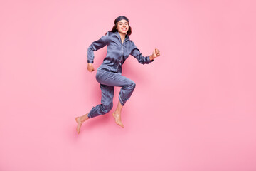 Full length photo portrait side profile of woman with eye mask running jumping up isolated on...