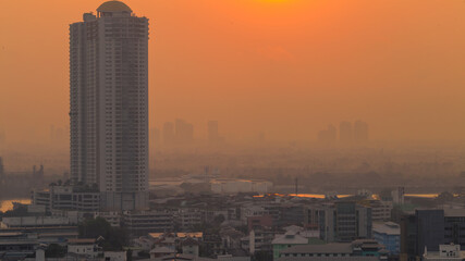 The blurred abstract background of the morning sun exposure to the tiny dust particles that surround the tall buildings in the capital, the long-term health issue of pollution.