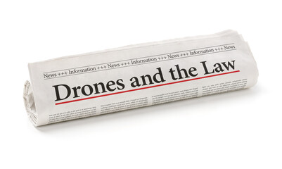 Rolled newspaper with the headline Drones and the Law
