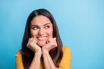 Photo portrait of smiling woman wearing yellow clothes looking blank isolated on vivid blue color...