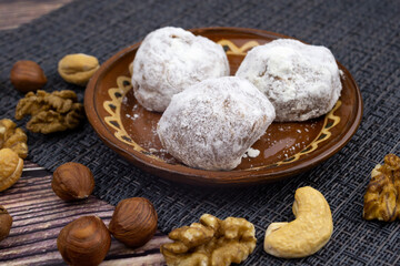 Chocolate walnut truffles, powdered sugar dairy sweets with walnuts, cashew fudge, sweet dessert