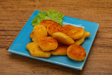 Fried chicken nuggets served salad leaves
