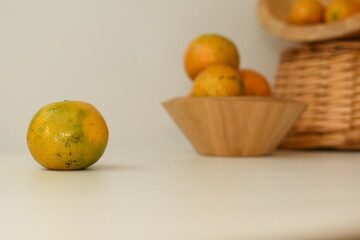 orange juice with fruits in the wooden bowl white background