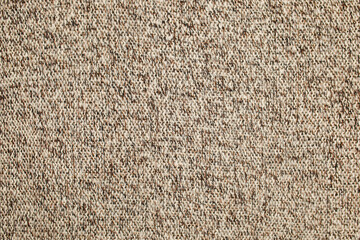 Texture knitted wool surface brown beige white. Background, wallpaper from fibers. Warm fabric.