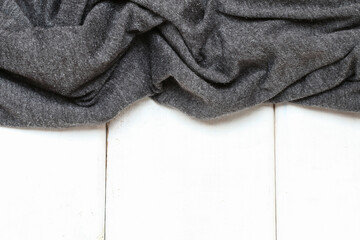 A grey, soft fabric background.