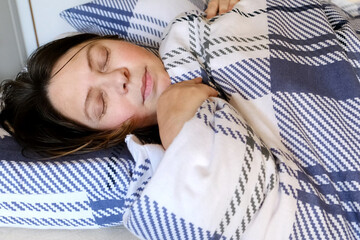 adult woman sleeping in bed, waking up, restless sleep, concept of insomnia, nightmares, noise from neighbors interferes