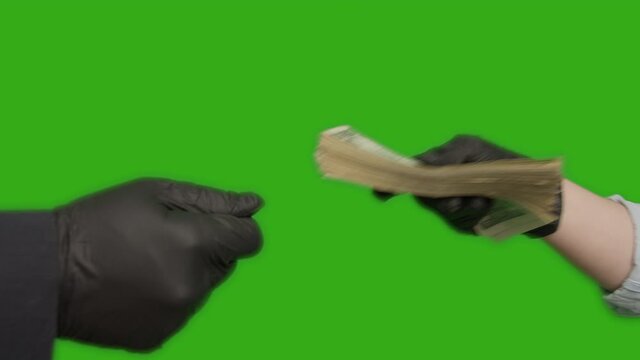 Making a deal, handing over a stack of money and shaking hands with rubber gloves