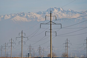 Almaty, Kazakhstan - 02.04.2021 : Power lines on the background of a large layer of smog covering...