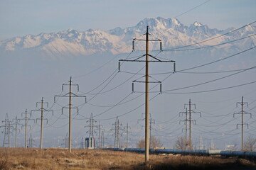 Almaty, Kazakhstan - 02.04.2021 : Power lines on the background of a large layer of smog covering...