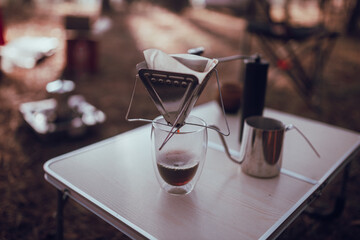 Close up photo of man preparing coffee at camping in forest
