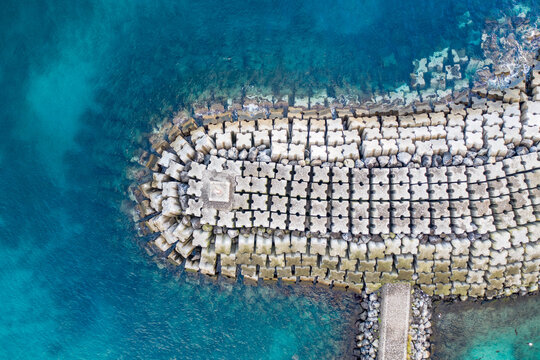 Aerial view of the breakwater at St. Mateus harbour on Terceira island. Azores archipelagos, Portugal.