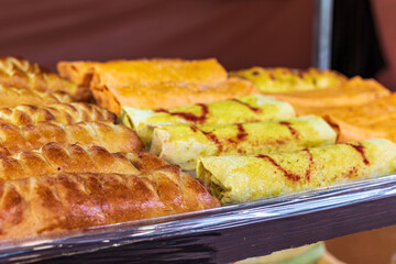 A culinary buffet with a presentation of various flour products. Kitchen in the open air. Street food market, festival, event. Street fair stand.