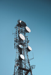 A big communication tower with a lot of GSM and internet antennas