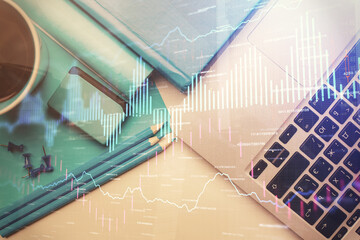 Double exposure of forex graph drawing over desktop background with computer. Concept of financial analysis. Top view.