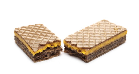 Wafer bar filled with cocoa and orange cream broken in half isolated on white background