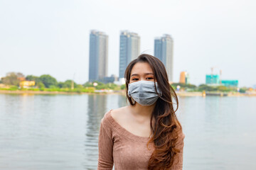 Shallow focus shot of an Asian female wearing a protective mask to prevent the spread of viruses