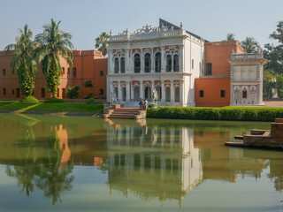 Fototapeta na wymiar View with reflection in pond of beautiful ancient renovated mansion and museum Sardar Bari in Sonargaon, Bangladesh