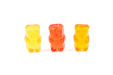 Children's vitamins in the form of bears are arranged in rows. A lot of multi-colored jelly sweets for children.