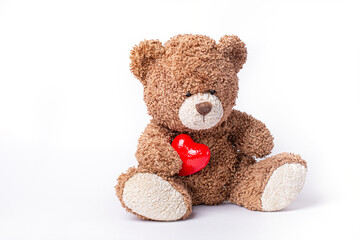 teddy bear holding  red heart isolated on white background