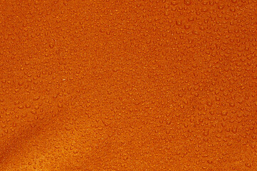 Fototapeta premium Orange and red cloth with water splashes for background and wallpaper