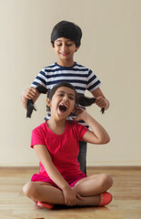 brother and sister playing at home	