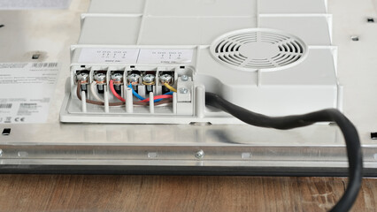 Electrical connection of the induction panel cooker, contacts, electricity. Pofessional wiring and...