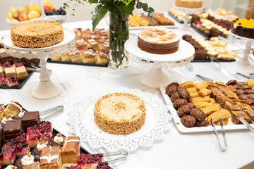 Dessert table with various pastries, coffee and nut cakes