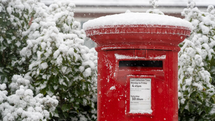 Red post box in the snow at Christmas