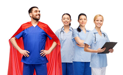 healthcare, profession and medicine concept - happy smiling male doctor in blue uniform and red superhero cape and female nurses over white background