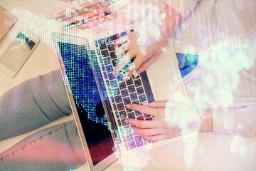 Double exposure of woman hands working on computer and forex graph hologram drawing. Top View. Financial analysis concept.