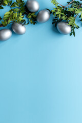 Silver Easter eggs on blue background. Top view decoration