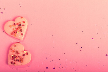 Valentine heart cookies dry strawberries on pink background with confetti