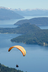 paragliding, vertical scene over lake and mountain