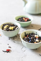 Different varieties of black tea with additives in bowls 